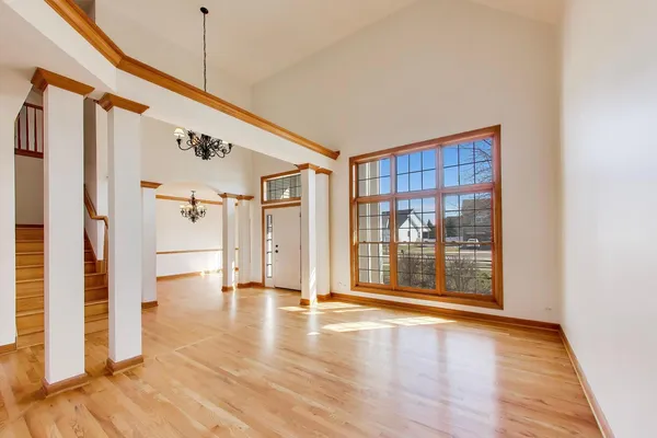 a view of a hallway with wooden floor and staircase