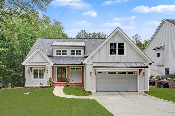 a front view of a house with yard and green space