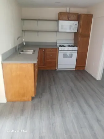 a kitchen with a sink and a stove top oven