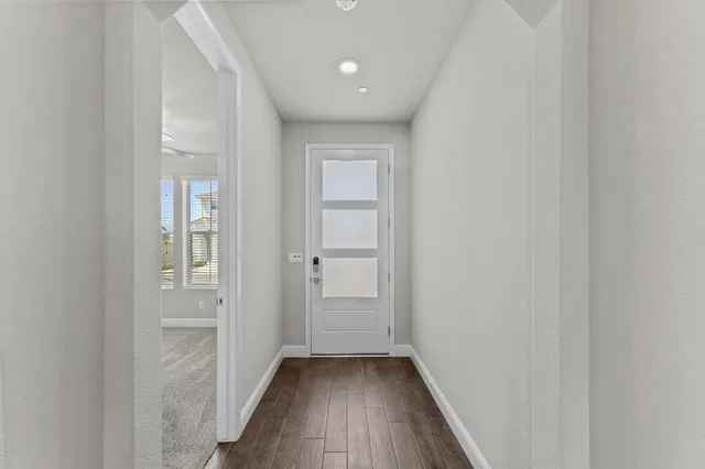 a view of a hallway with wooden floor