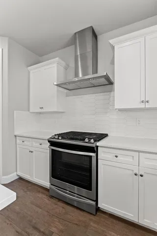 a stove top oven sitting inside of a kitchen