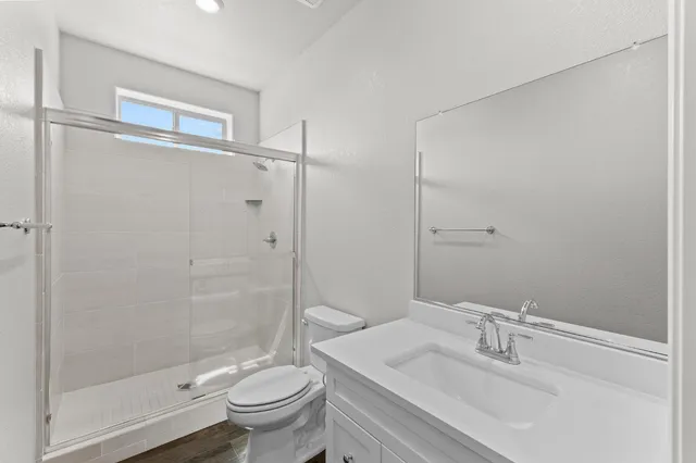 a bathroom with a sink toilet and shower