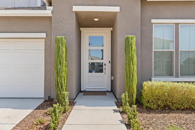 a front view of a house with a garden