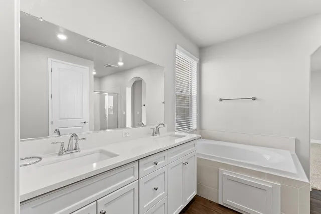 a spacious bathroom with a granite countertop sink and a mirror