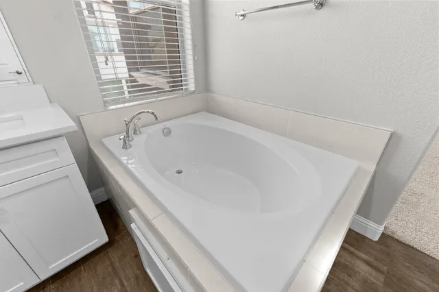 a bathroom with a bathtub and a window