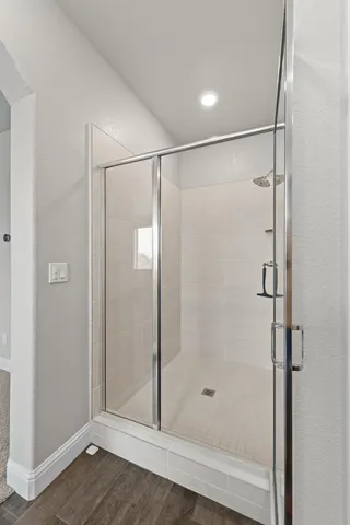 a bathroom with a glass shower door