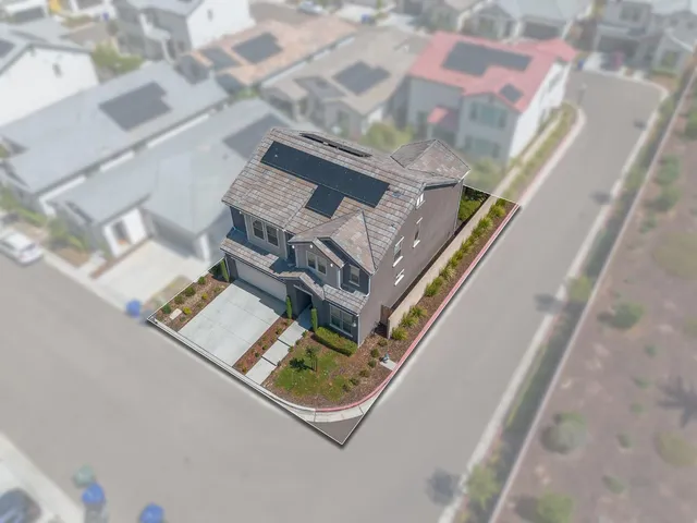 an aerial view of residential house with outdoor space and parking