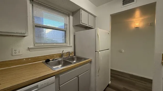 a kitchen with a sink and refrigerator
