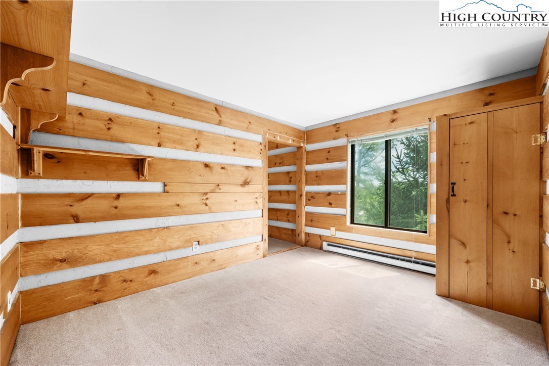 106 Sherry Lane, Unit 106 Boone, NC 28607 - Photo 12 of 27 a view of an empty room with wooden floor and windows