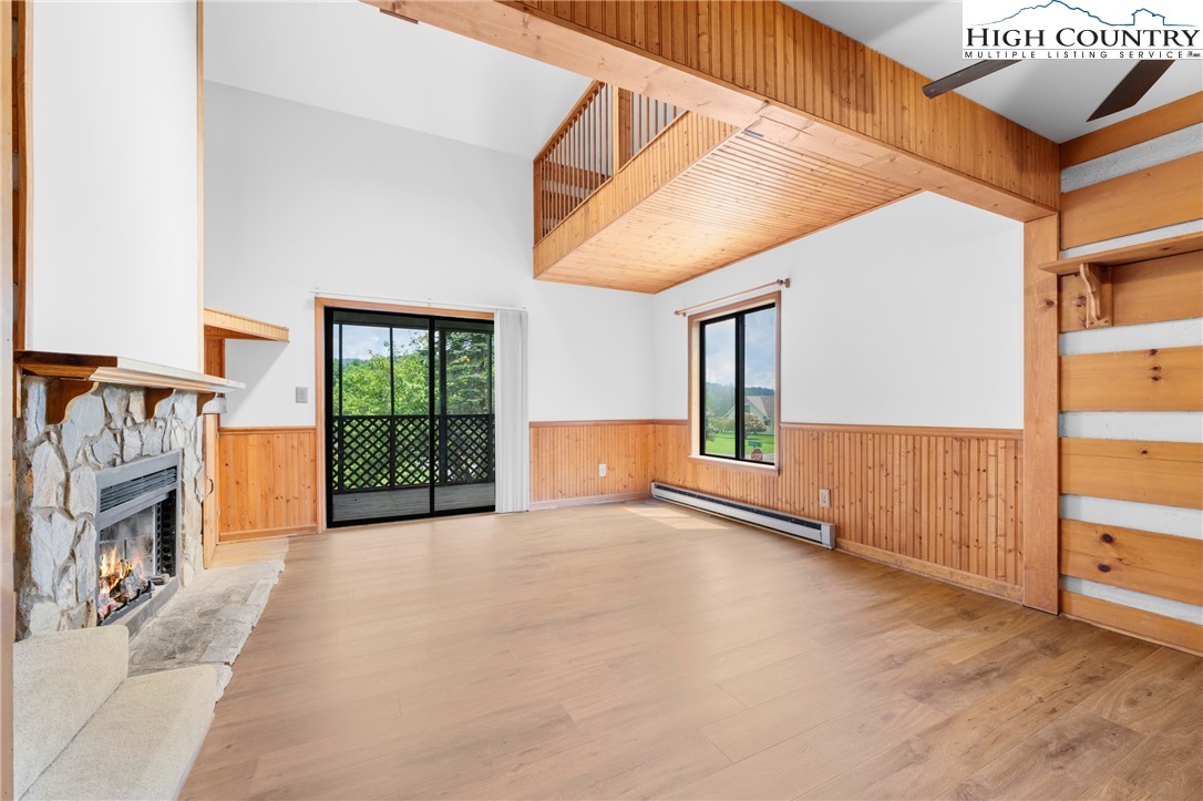 106 Sherry Lane, Unit 106 Boone, NC 28607 - Photo 2 of 27 a view of an empty room with a fireplace and windows