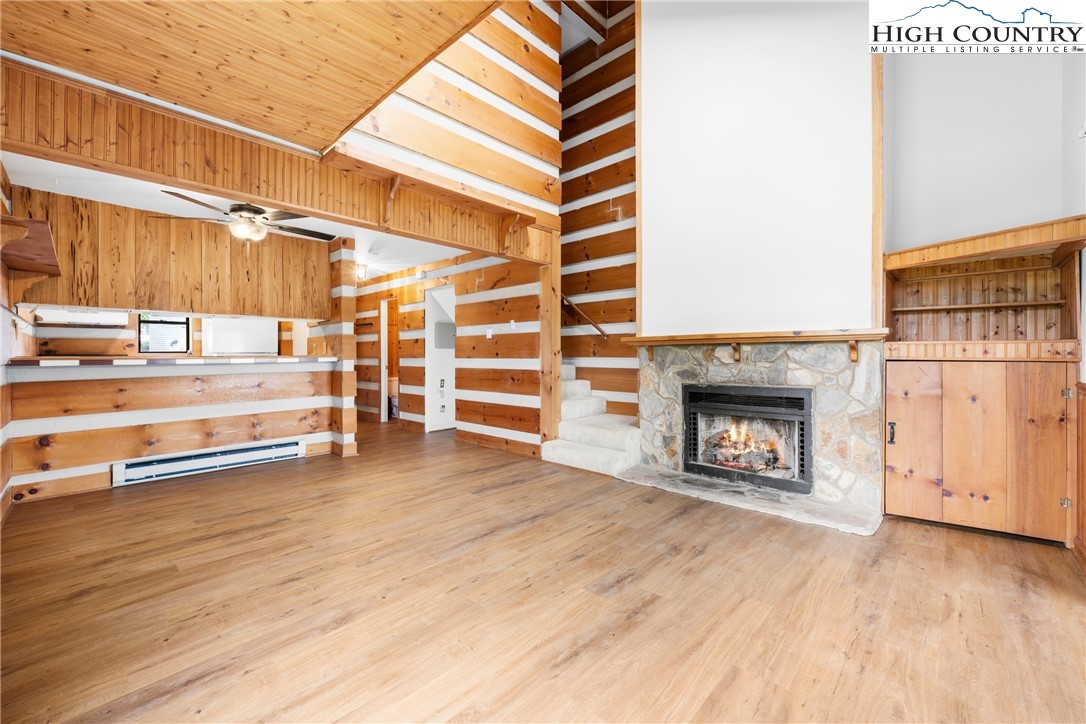 106 Sherry Lane, Unit 106 Boone, NC 28607 - Photo 3 of 27 a view of a room with wooden floor and a fireplace