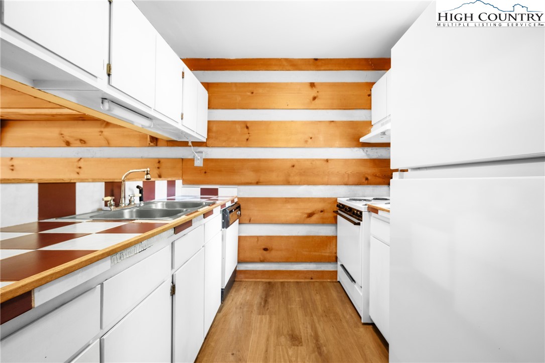 106 Sherry Lane, Unit 106 Boone, NC 28607 - Photo 5 of 27 a view of a kitchen with wooden floor and a sink