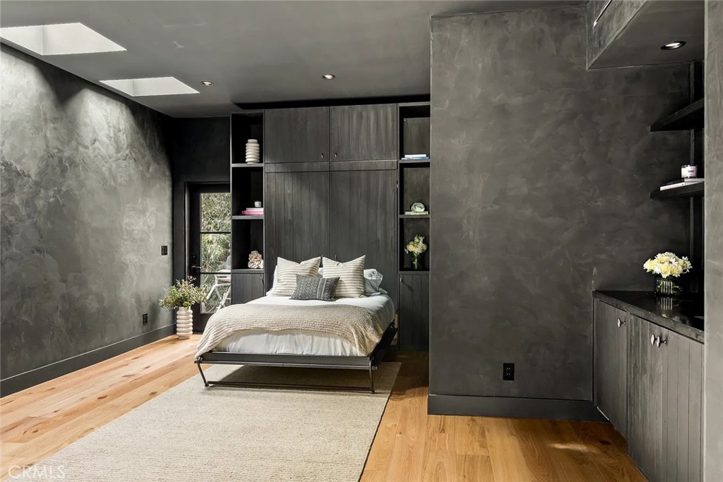 738 San Lorenzo Street Santa Monica, CA 90402 - Photo 21 of 50 a bedroom with a bed and wooden floor