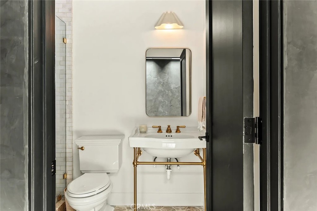 738 San Lorenzo Street Santa Monica, CA 90402 - Photo 22 of 50 a bathroom with a toilet sink vanity and mirror