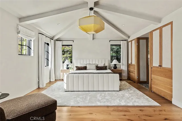 a bedroom with bed and wooden floor