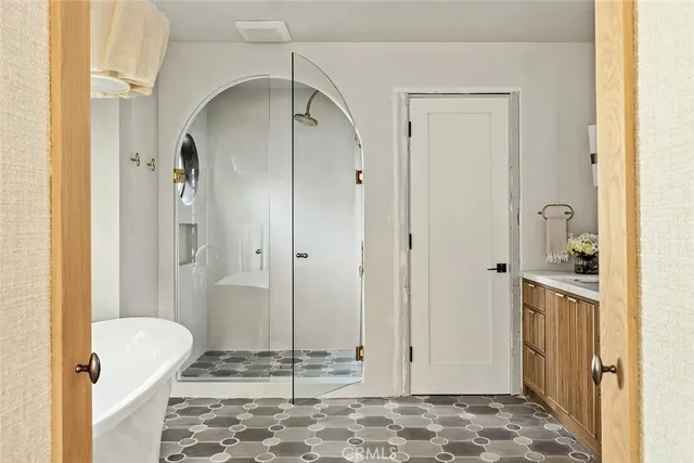 a white bath tub sitting in a bathroom next to a window