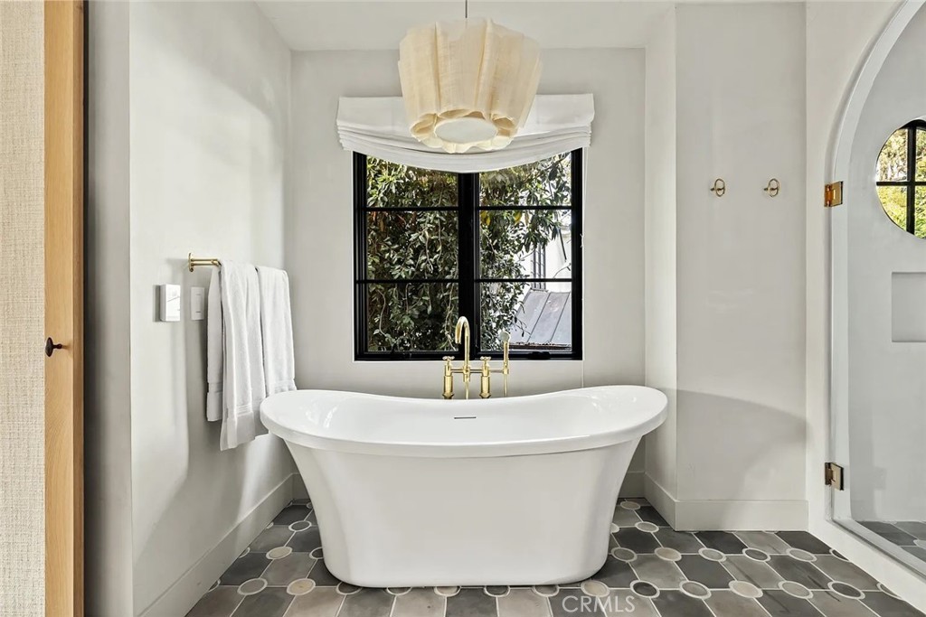 738 San Lorenzo Street Santa Monica, CA 90402 - Photo 33 of 50 a white bath tub sitting in a bathroom next to a window
