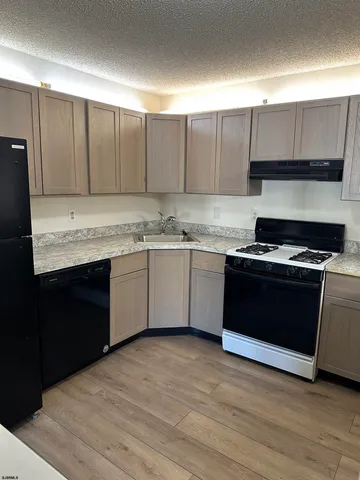 a kitchen with a sink and a stove top oven
