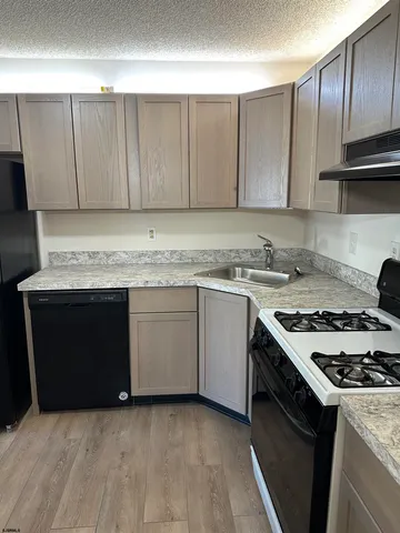 a kitchen with a sink stove and cabinets
