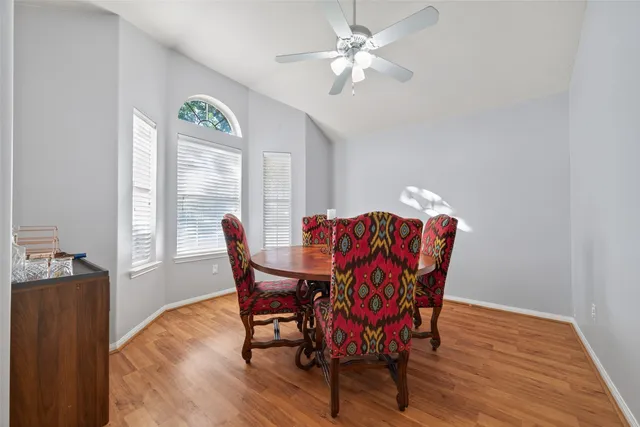 a view of a dining room with furniture and wooden floor