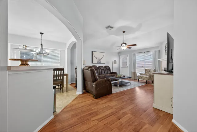 a living room with furniture and a chandelier
