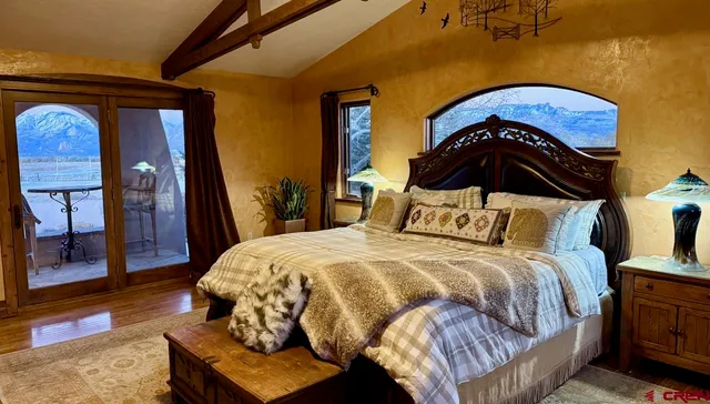 a bedroom with a bed and dresser with rug