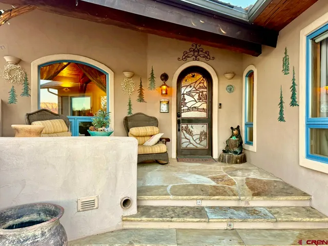 a living room with a bed furniture and a large window