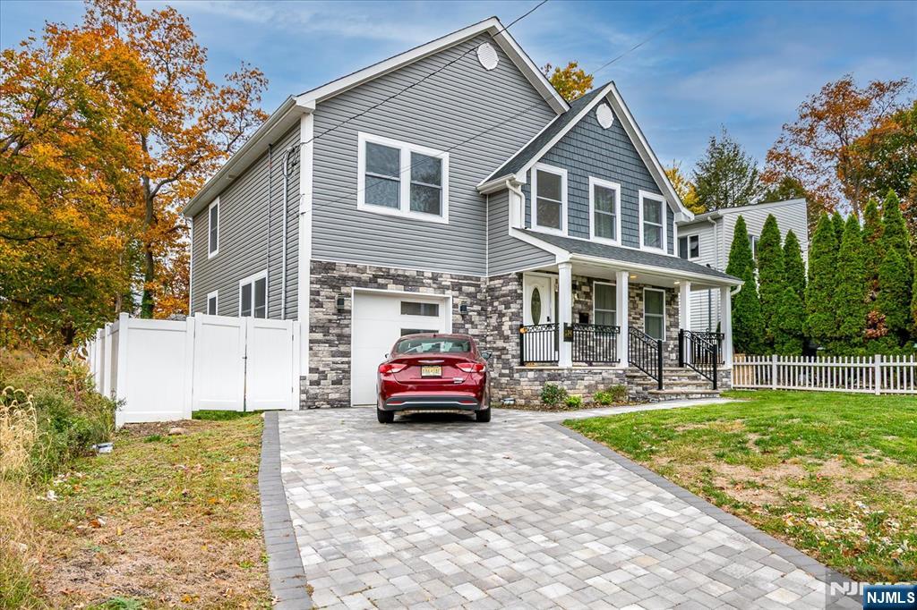 174 Manhattan Avenue Teaneck, NJ 07666 - Photo 1 of 45 a front view of a house with a yard