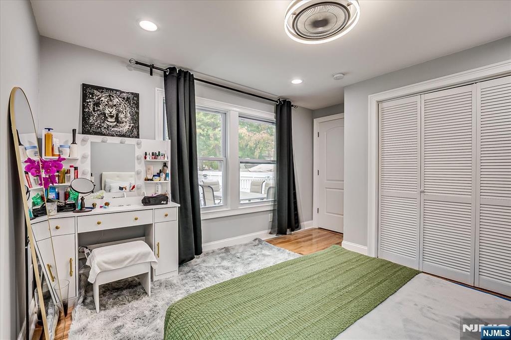 174 Manhattan Avenue Teaneck, NJ 07666 - Photo 15 of 45 a bedroom with a bed and a chandelier