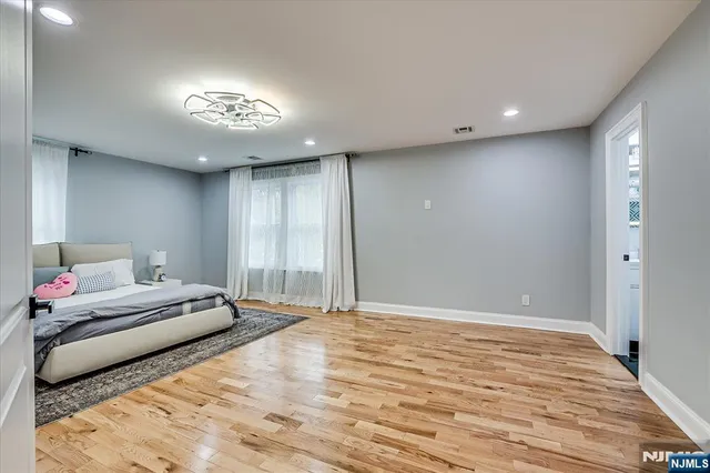 a bedroom with a large bed and a chandelier