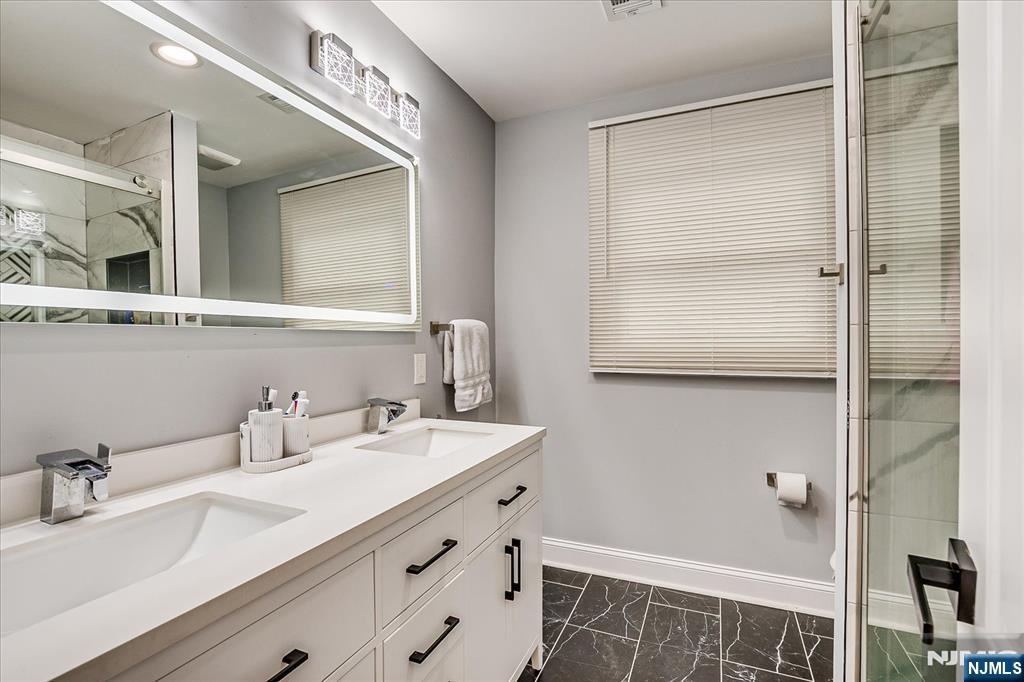 174 Manhattan Avenue Teaneck, NJ 07666 - Photo 20 of 45 a bathroom with a sink and a mirror
