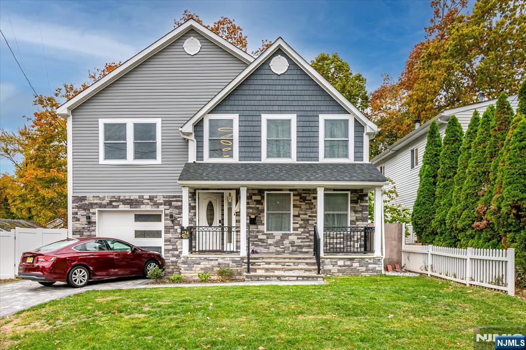 174 Manhattan Avenue Teaneck, NJ 07666 - Photo 2 of 45 a front view of a house with a yard