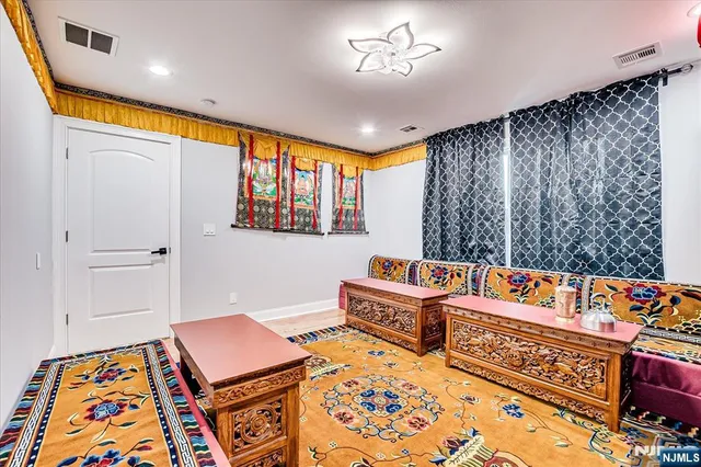 a reading room with furniture and a rug