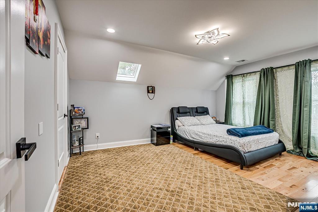 174 Manhattan Avenue Teaneck, NJ 07666 - Photo 23 of 45 a bedroom with furniture and a window