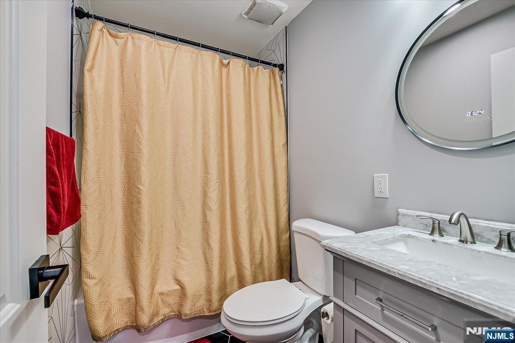174 Manhattan Avenue Teaneck, NJ 07666 - Photo 25 of 45 a bathroom with a granite countertop sink and a mirror