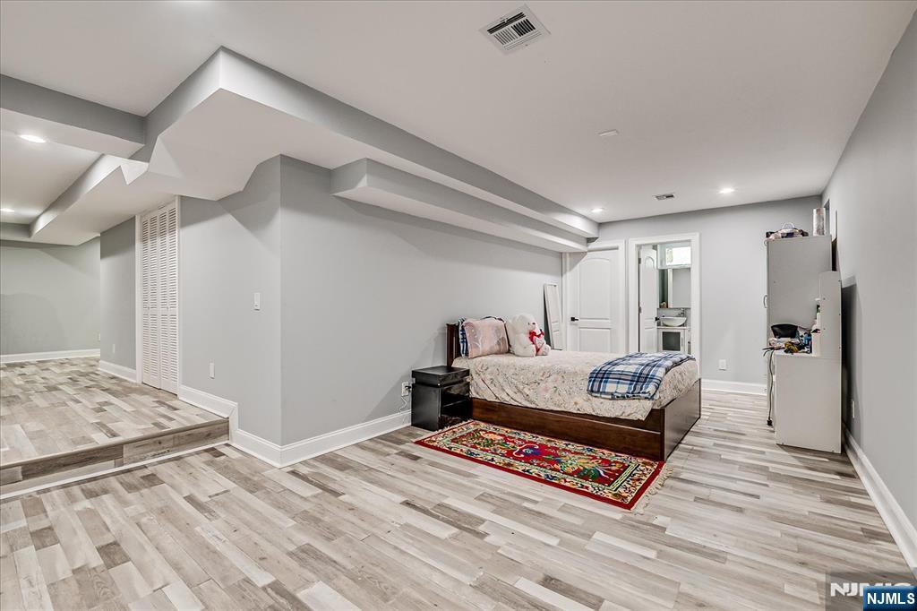 174 Manhattan Avenue Teaneck, NJ 07666 - Photo 27 of 45 a living room with furniture and a wooden floor