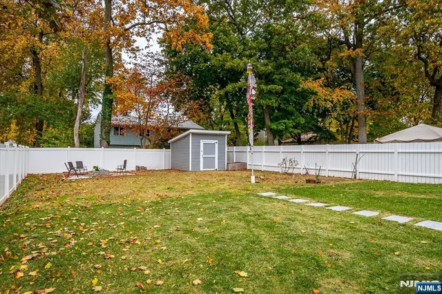 a view of backyard of house with green space