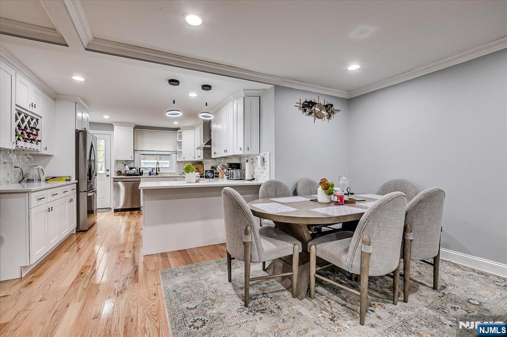 174 Manhattan Avenue Teaneck, NJ 07666 - Photo 7 of 45 a kitchen with a table chairs a sink and dishwasher