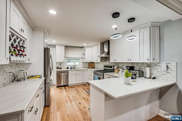 a kitchen with a refrigerator a sink and wooden cabinets