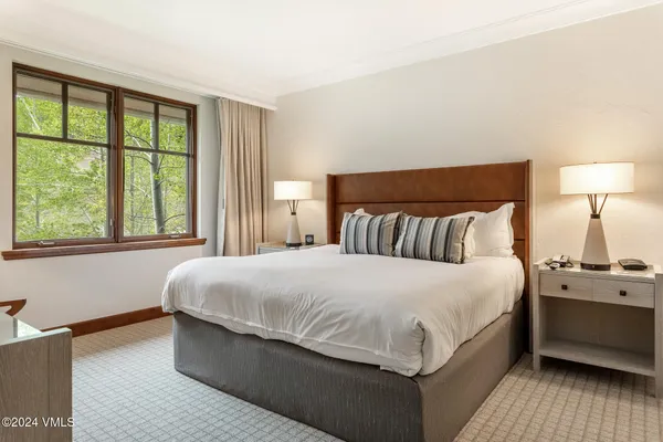 a bedroom with a bed and window