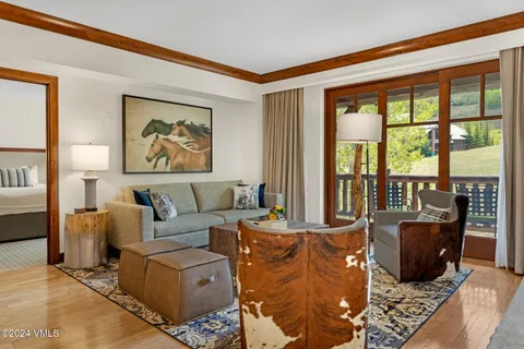 a living room with furniture large window and flat screen tv
