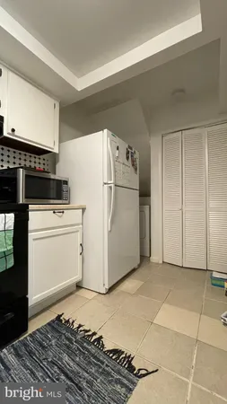 a utility room with cabinets washer and dryer