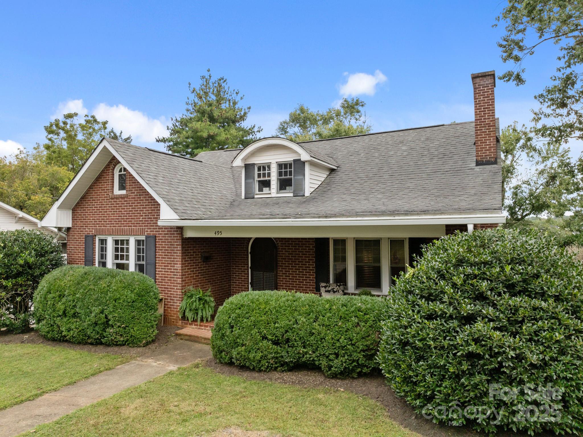 495 Fairview Road Asheville, NC 28803 - Photo 1 of 41 a front view of a house with a garden