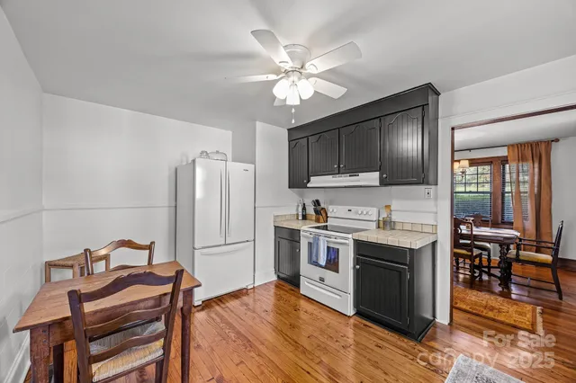 a kitchen with stainless steel appliances granite countertop a stove refrigerator and microwave