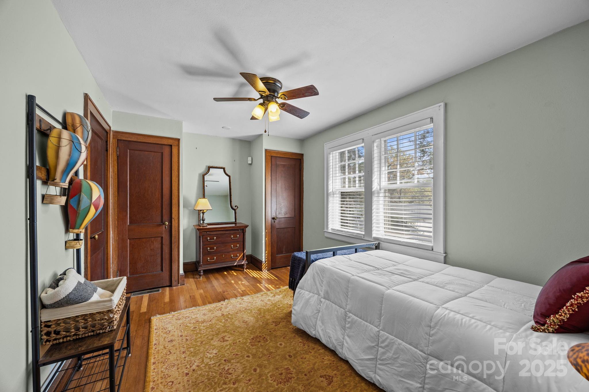 495 Fairview Road Asheville, NC 28803 - Photo 24 of 41 a bedroom with a bed dresser and a window