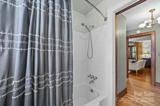 a bathroom with shower a bathtub and a shower