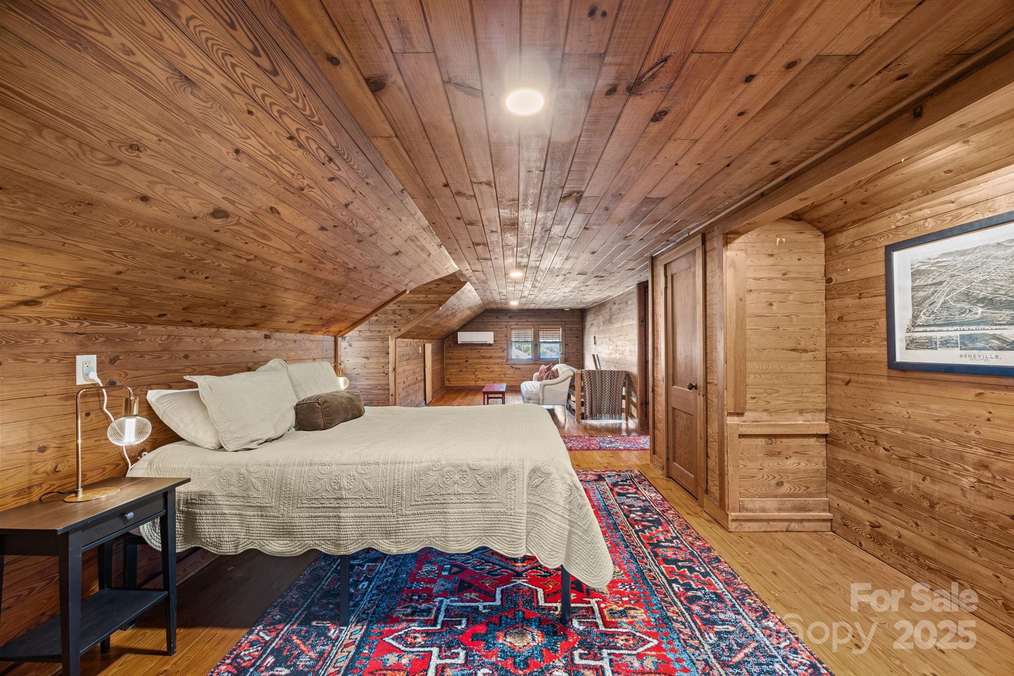 495 Fairview Road Asheville, NC 28803 - Photo 29 of 41 a bedroom with a bed and a chandelier