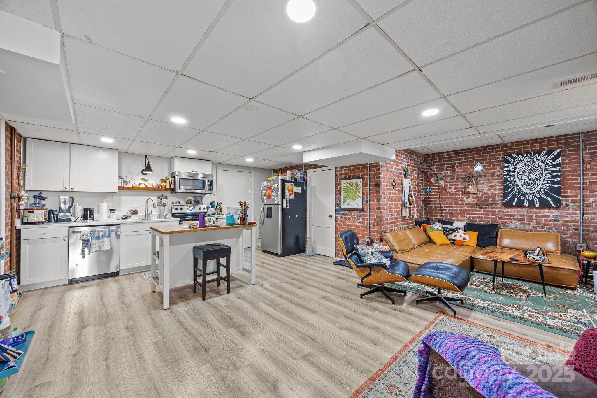 495 Fairview Road Asheville, NC 28803 - Photo 33 of 41 a view of a kitchen with furniture and wooden floor