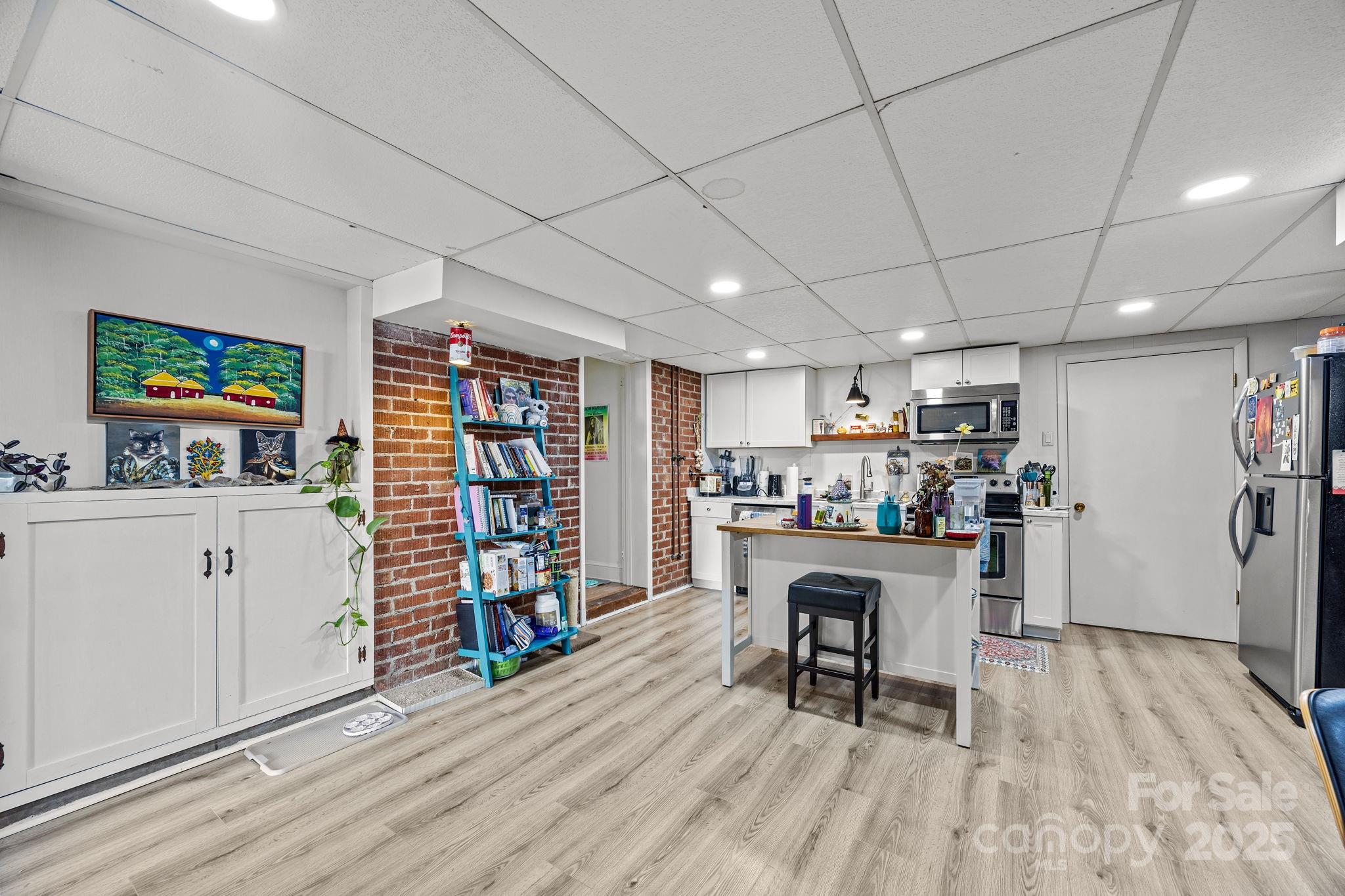 495 Fairview Road Asheville, NC 28803 - Photo 34 of 41 a room with furniture and a wooden floor