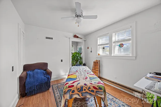 a bedroom with two beds and a window